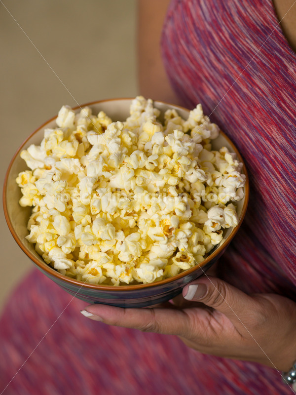 Royalty Free Stock Photo: Plus Size Black Woman with Bowl of Popcorn - Body Liberation Photos