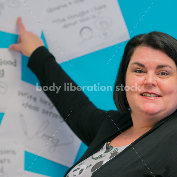 Royalty Free Stock Photo: Plus Size Elementary School Teacher in Classroom - Body Liberation Photos