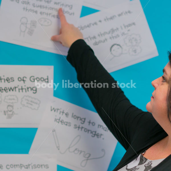 Royalty Free Stock Photo: Plus Size Elementary School Teacher in Classroom - Body Liberation Photos