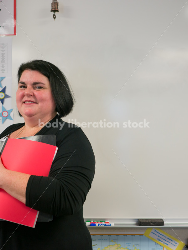 Royalty Free Stock Photo: Plus Size Elementary School Teacher in Classroom - Body Liberation Photos
