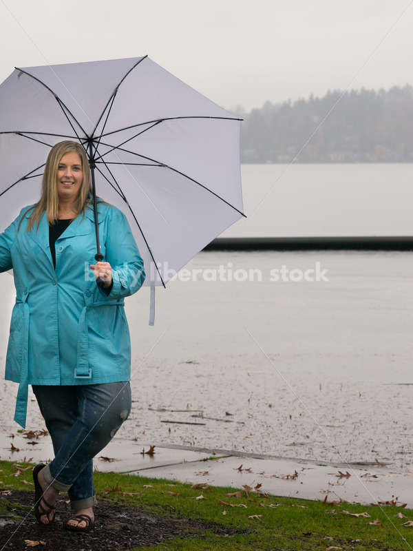 Royalty Free Stock Photo: Plus Size Woman Outdoors with Umbrella, Rain and Autumn Lake - Body Liberation Photos