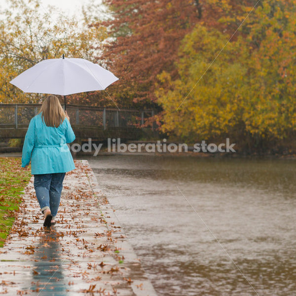 Royalty Free Stock Photo: Plus Size Woman Walks Outdoors by Lake - Body Liberation Photos