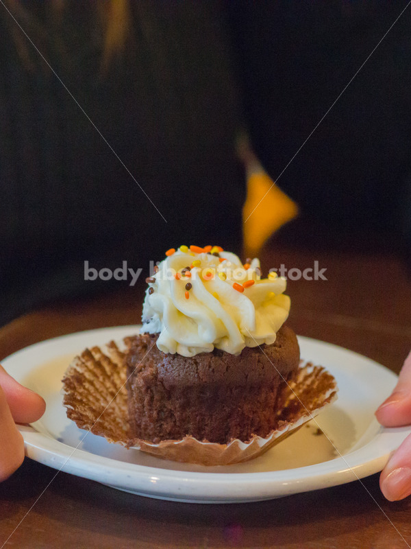 Royalty Free Stock Photo: Plus Size Woman with Cupcake in Coffee Shop - Body Liberation Photos