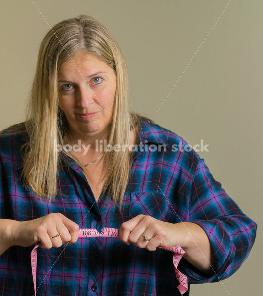 Royalty Free Stock Photo for Dieting Recovery: Woman Breaking Tape Measure - Body Liberation Photos