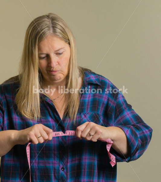 Royalty Free Stock Photo for Dieting Recovery: Woman Breaking Tape Measure - Body Liberation Photos