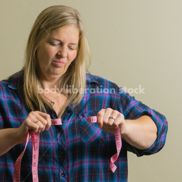 Royalty Free Stock Photo for Dieting Recovery: Woman Breaking Tape Measure - Body Liberation Photos