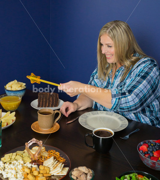 Royalty Free Stock Photo for Intuitive Eating: Plus Size Woman Chooses from Variety of Foods on Dining Table - Body Liberation Photos