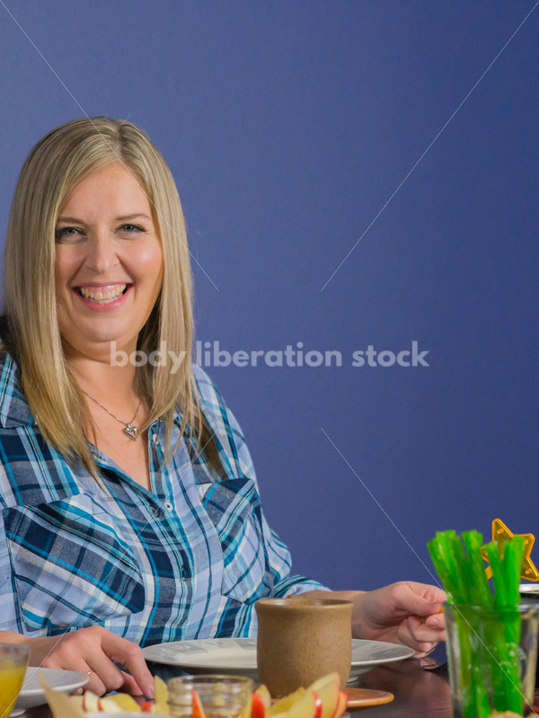 Royalty Free Stock Photo for Intuitive Eating: Plus Size Woman Chooses from Variety of Foods on Dining Table - Body Liberation Photos