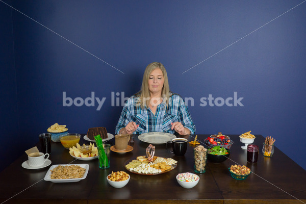 Royalty Free Stock Photo for Intuitive Eating: Plus Size Woman Chooses from Variety of Foods on Dining Table - Body Liberation Photos