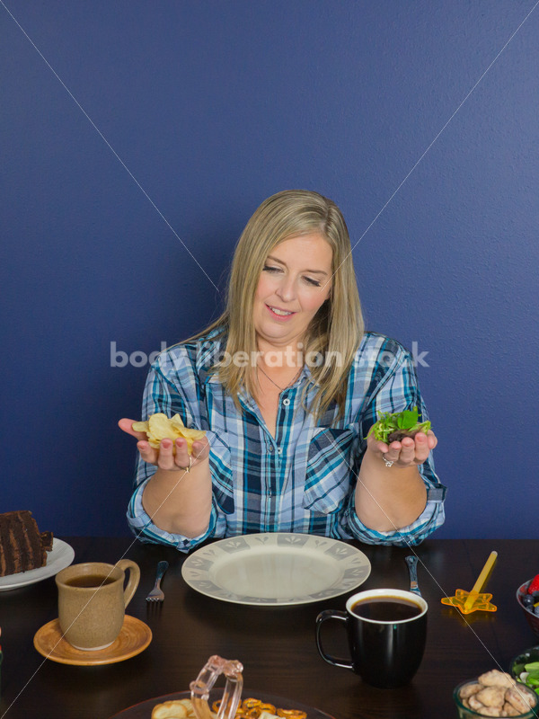 Royalty Free Stock Photo for Intuitive Eating: Plus Size Woman Chooses from Variety of Foods on Dining Table - Body Liberation Photos