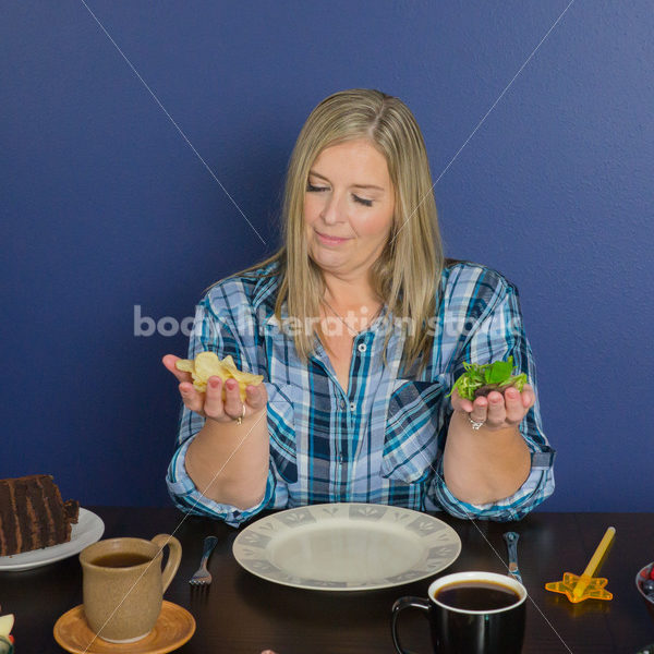 Royalty Free Stock Photo for Intuitive Eating: Plus Size Woman Chooses from Variety of Foods on Dining Table - Body Liberation Photos