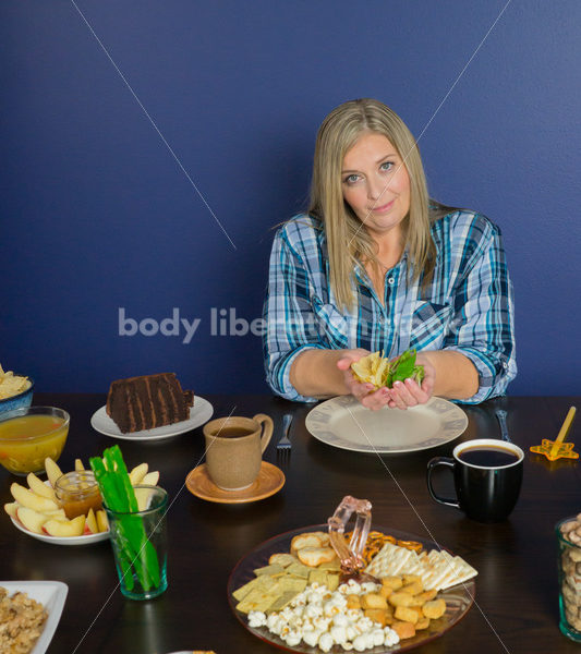 Royalty Free Stock Photo for Intuitive Eating: Plus Size Woman Chooses from Variety of Foods on Dining Table - Body Liberation Photos