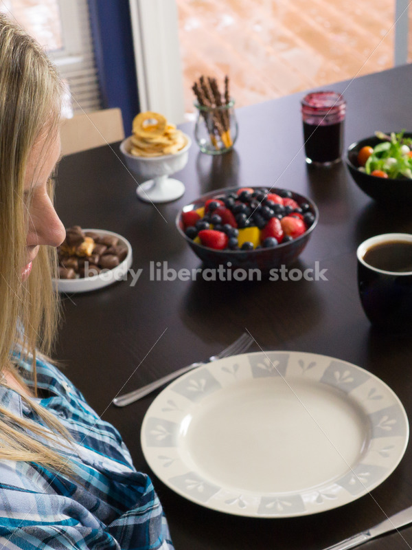 Royalty Free Stock Photo for Intuitive Eating: Plus Size Woman Considers Variety of Foods on Dining Table - Body Liberation Photos