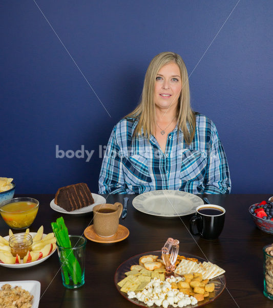 Royalty Free Stock Photo for Intuitive Eating: Plus Size Woman Considers Variety of Foods on Dining Table - Body Liberation Photos