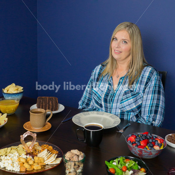 Royalty Free Stock Photo for Intuitive Eating: Plus Size Woman Considers Variety of Foods on Dining Table - Body Liberation Photos