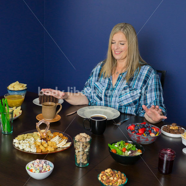 Royalty Free Stock Photo for Intuitive Eating: Plus Size Woman Considers Variety of Foods on Dining Table - Body Liberation Photos