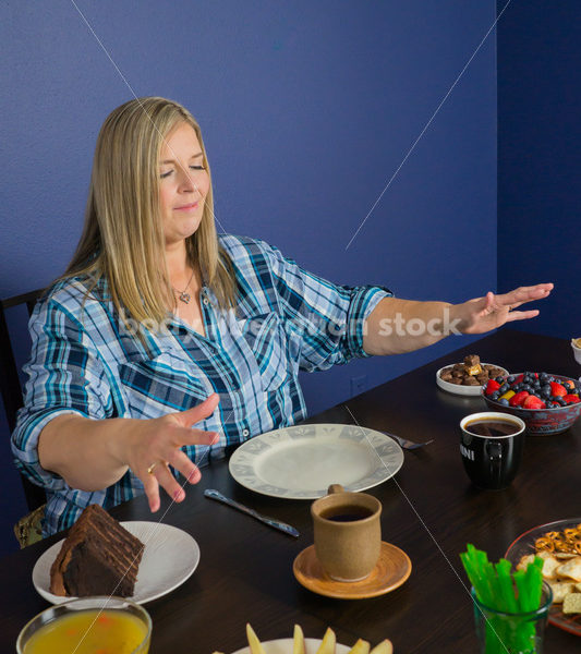 Royalty Free Stock Photo for Intuitive Eating: Plus Size Woman Considers Variety of Foods on Dining Table - Body Liberation Photos