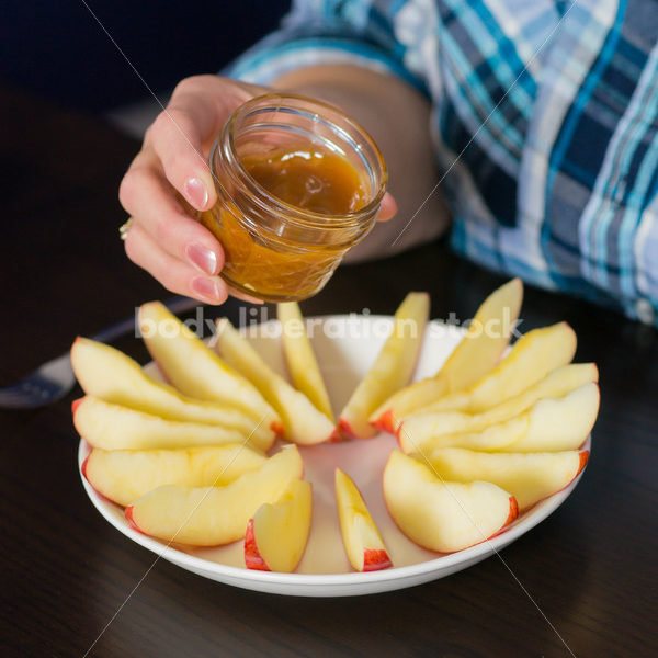 Royalty Free Stock Photo for Intuitive Eating: Plus Size Woman Eats Caramel Dip - Body Liberation Photos