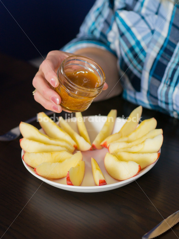 Royalty Free Stock Photo for Intuitive Eating: Plus Size Woman Eats Caramel Dip - Body Liberation Photos