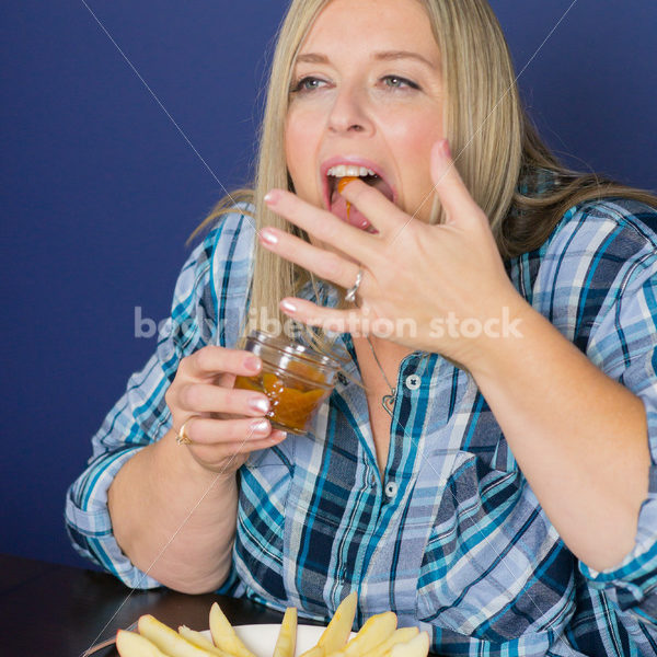 Royalty Free Stock Photo for Intuitive Eating: Plus Size Woman Eats Caramel Dip - Body Liberation Photos