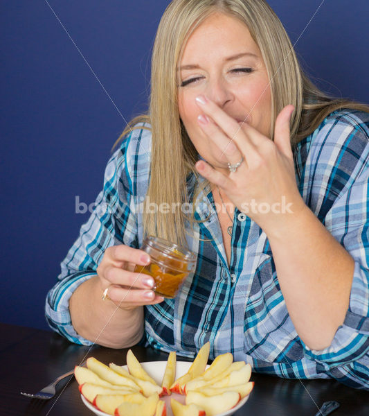 Royalty Free Stock Photo for Intuitive Eating: Plus Size Woman Eats Caramel Dip - Body Liberation Photos