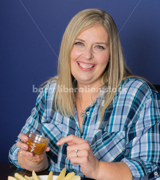 Royalty Free Stock Photo for Intuitive Eating: Plus Size Woman Eats Caramel Dip - Body Liberation Photos