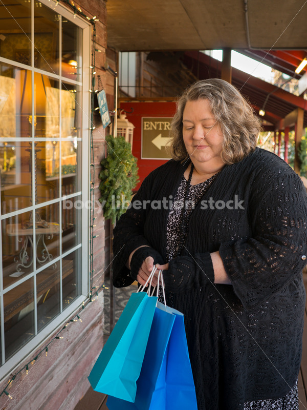 Shopping & Retail Stock Photo: Plus Size Woman with Shopping Bags Outside Small Boutique Store - Body Liberation Photos