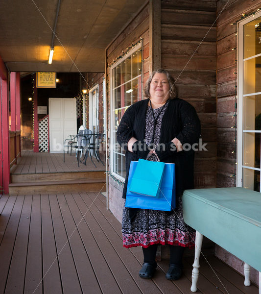 Shopping & Retail Stock Photo: Plus Size Woman with Shopping Bags Outside Small Boutique Store - Body Liberation Photos