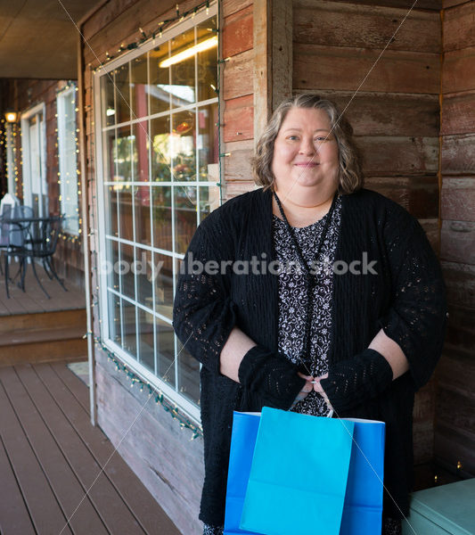 Shopping & Retail Stock Photo: Plus Size Woman with Shopping Bags Outside Small Boutique Store - Body Liberation Photos