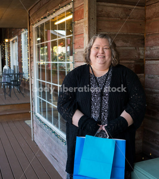 Shopping & Retail Stock Photo: Plus Size Woman with Shopping Bags Outside Small Boutique Store - Body Liberation Photos