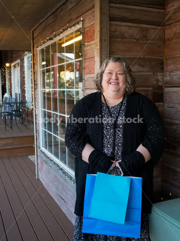 Shopping & Retail Stock Photo: Plus Size Woman with Shopping Bags Outside Small Boutique Store - Body Liberation Photos