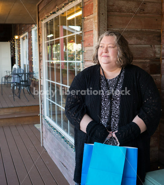 Shopping & Retail Stock Photo: Plus Size Woman with Shopping Bags Outside Small Boutique Store - Body Liberation Photos