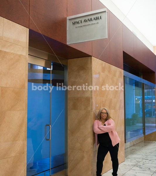 Small Business Stock Image: Black LGBT Businesswoman with Vacant Storefront - Body Liberation Photos