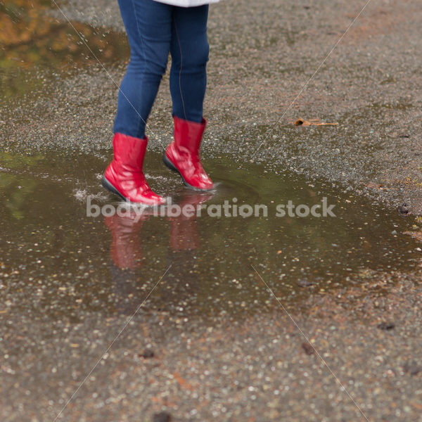 Stock Photo: Asian American Woman Playing in Puddles on a Rainy Day - Body Liberation Photos