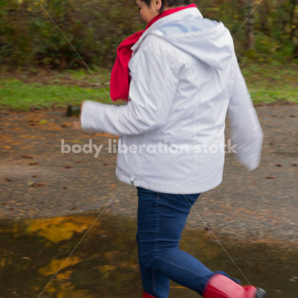 Stock Photo: Asian American Woman Playing in Puddles on a Rainy Day - Body Liberation Photos