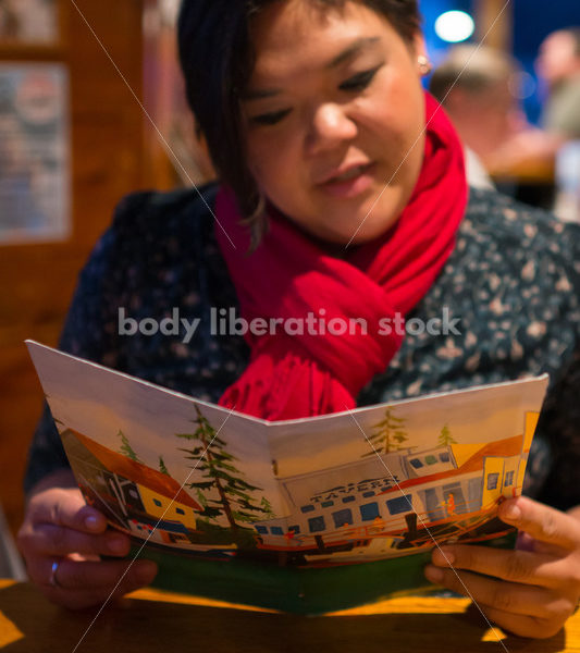 Stock Photo: Intuitive Eating – Asian American Woman with Menu - Body Liberation Photos