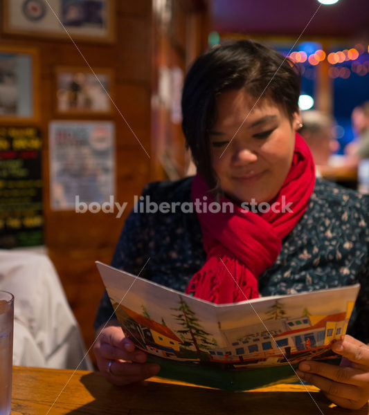 Stock Photo: Intuitive Eating – Asian American Woman with Menu - Body Liberation Photos