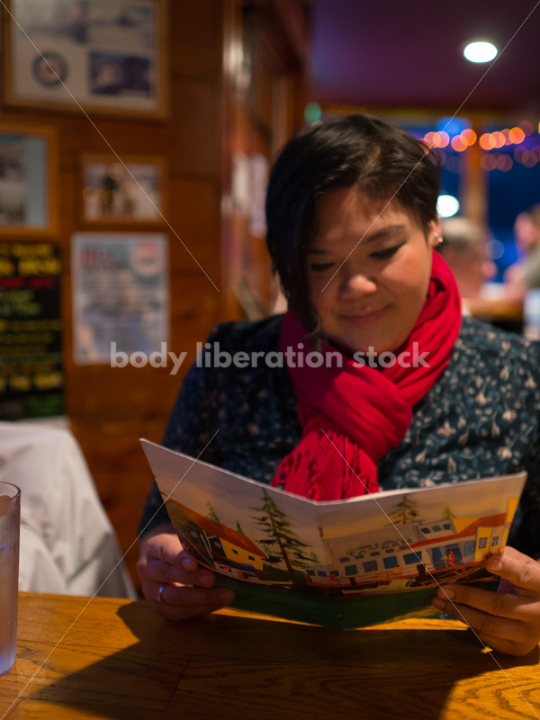 Stock Photo: Intuitive Eating – Asian American Woman with Menu - Body Liberation Photos