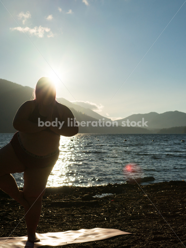 Stock Photo: Plus Size Woman Practices Yoga on Mountain Lake Shore at Sunset - Body positive stock and client photography + more | Seattle