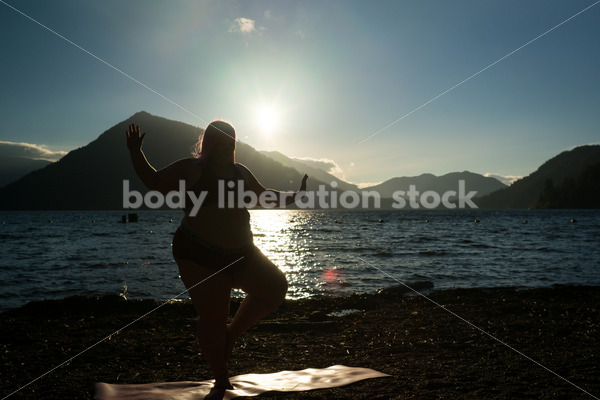 Stock Photo: Plus Size Woman Practices Yoga on Mountain Lake Shore at Sunset - Body positive stock and client photography + more | Seattle