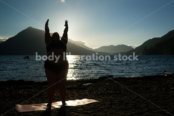 Stock Photo: Plus Size Woman Practices Yoga on Mountain Lake Shore at Sunset - Body positive stock and client photography + more | Seattle