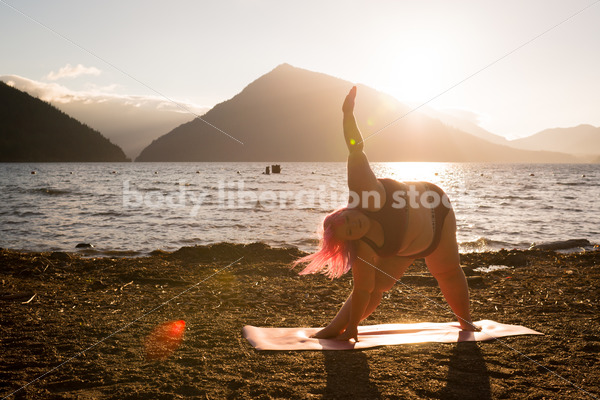 Stock Photo: Plus Size Woman Practices Yoga on Mountain Lake Shore at Sunset - Body positive stock and client photography + more | Seattle