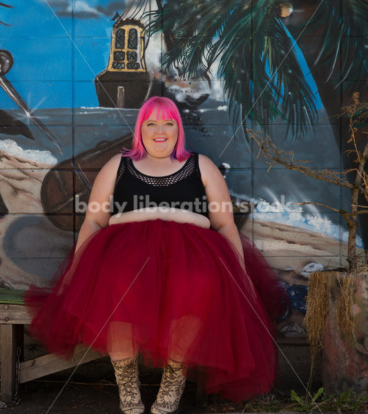 Stock Photo: Plus Size Woman with Pink Hair Seated in Tutu with Mural - Body Liberation Photos