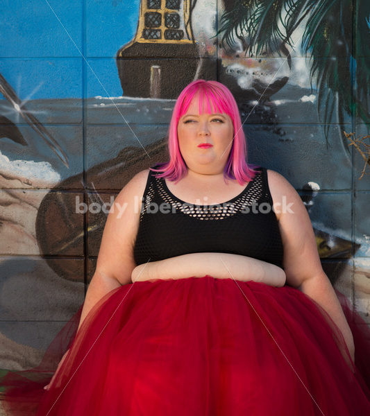 Stock Photo: Plus Size Woman with Pink Hair Seated in Tutu with Mural - Body Liberation Photos