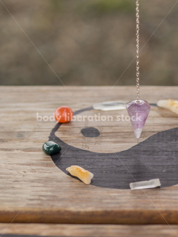 Stock Photo: Scrying, Clearing Gemstones and Pendulum Work with Yin and Yang and Asian American Hand - Body Liberation Photos