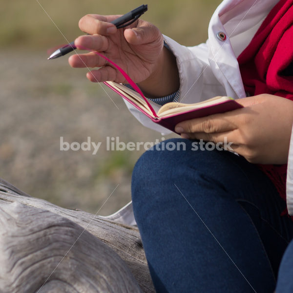 Stock Photo: Young Asian American Woman Writing in Journal Outdoors - Body Liberation Photos