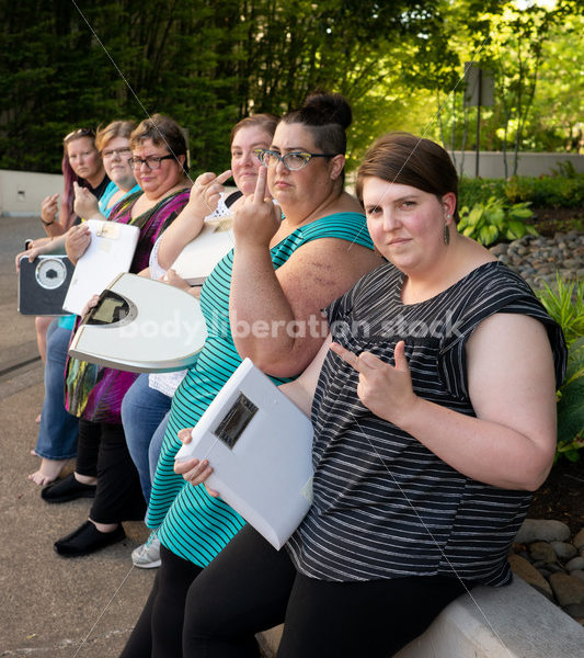 Anti-Diet Stock Image: Women Give the Finger to Bathroom Scales - Body Liberation Photos