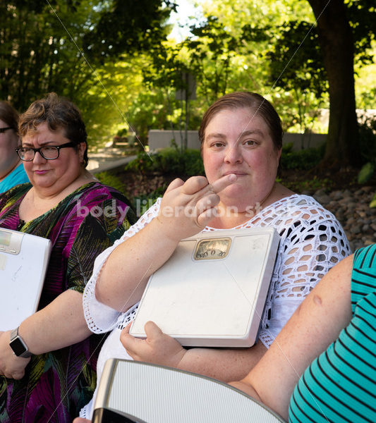 Anti-Diet Stock Image: Women Give the Finger to Bathroom Scales - Body Liberation Photos