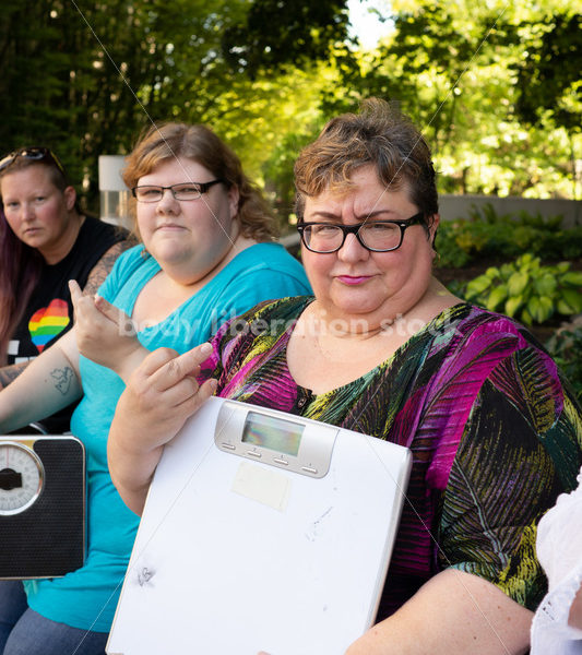 Anti-Diet Stock Image: Women Give the Finger to Bathroom Scales - Body Liberation Photos