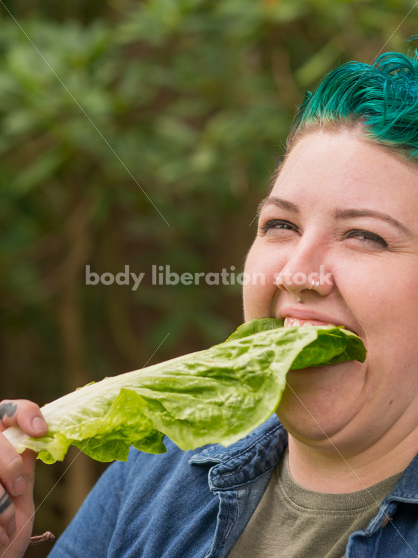 Diverse Gardening Stock Photo: Agender Person Eats Lettuce in Garden - Body Liberation Photos